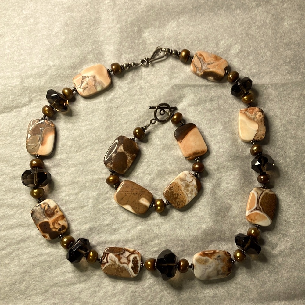 Matching stone necklace and bracelet: dusty pink cream brown with bronze beads.